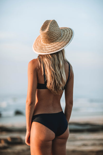 Woman at ocean wearing the Maidstone Bikini Bottom in ribbed midnight - Summer Label Swimwear